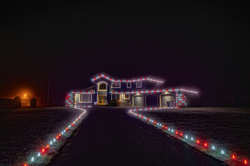 Red and white roofline with an illuminated driveway